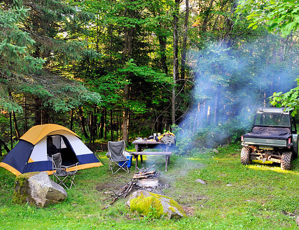 camping site with smoke from a fire stock photo