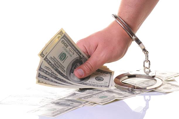 istock Hand in handcuffs try to get money 111963727