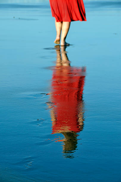 istock Red Dress Woman Reflected on Beach 111964138