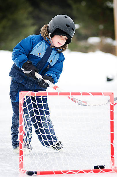 istock young boy playing hockey 111964786