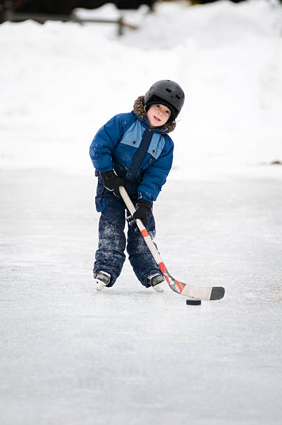 istock young boy playing ice hockey 111964788