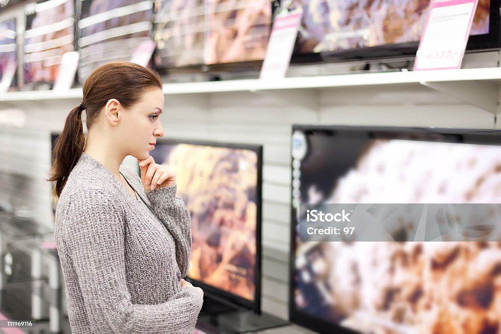Woman checks out televisions while browsing in Walmart The woman buys a TV in shop. Shopping Stock Photo