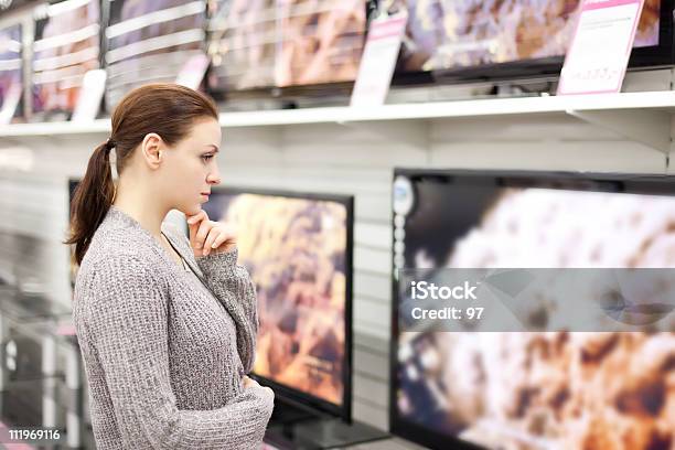 Woman Checks Out Televisions While Browsing In Walmart Stock Photo - Download Image Now