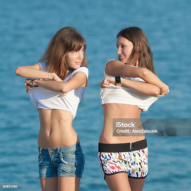 Young Women Undress Stock Photo - Download Image Now - Adults Only, Undressing, Women