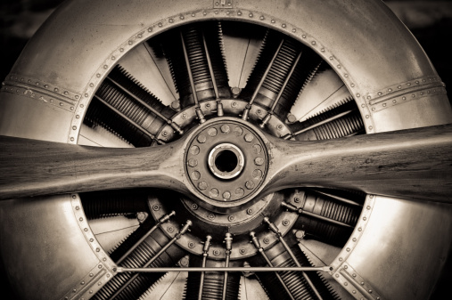 Propeller engine of vintage airplane isolated on white.