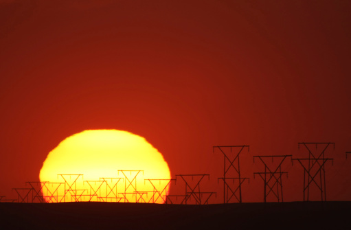 sunset behind energy masts in Namibia