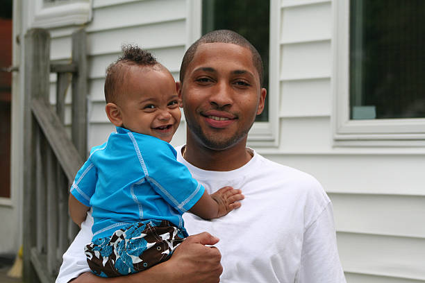 African-American father with Latin-American son African American father with biracial latin american son in backyard single father stock pictures, royalty-free photos & images