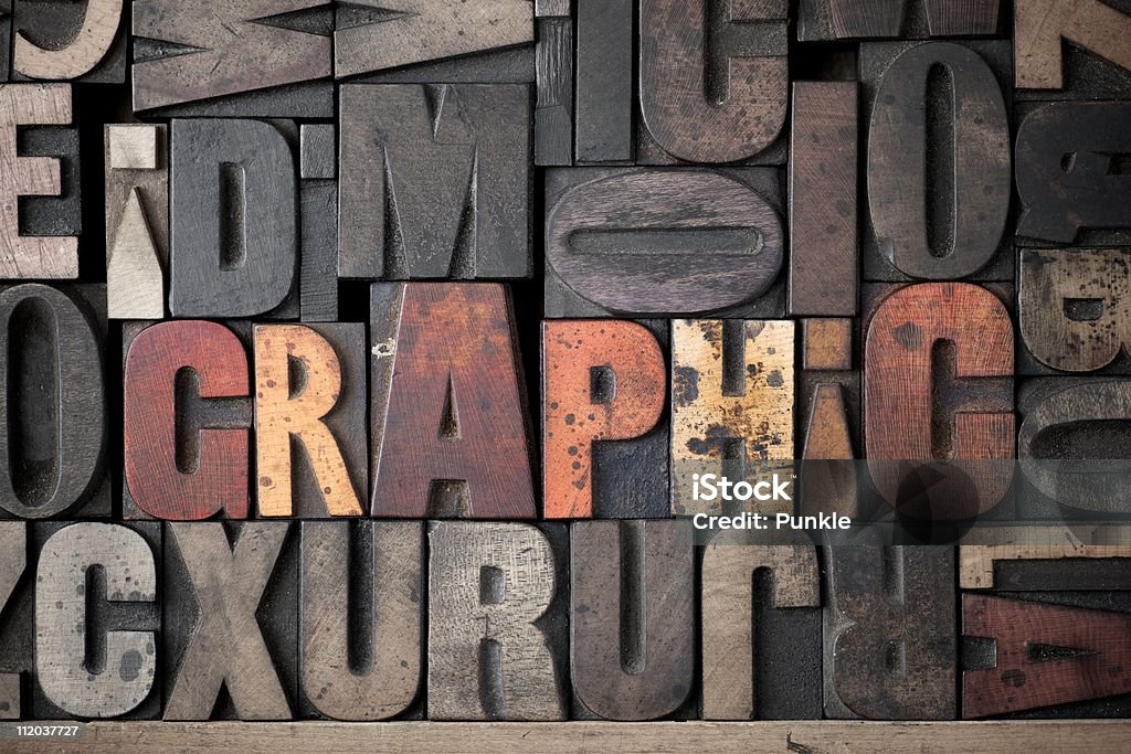 Graphic wooden letters stamps set lettering stock alphabet The word 'Graphic' spelled out in very old letterpress blocks. Color Image Stock Photo