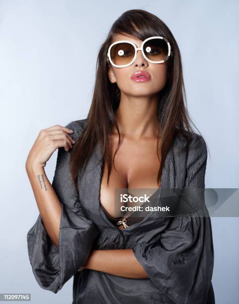 Portrait Of A Sexy And Stylish Brunette Wearing Sunglasses Stock Photo - Download Image Now