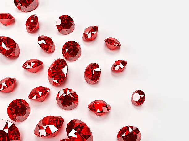 Many red rubies on a white surface stock photo