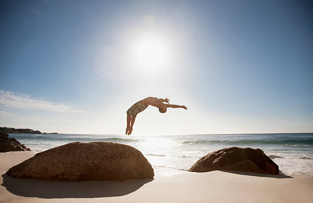 Man doing backflip on beach  person falling backwards stock pictures, royalty-free photos & images