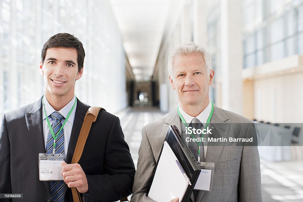 Businessmen standing together in office  Badge Stock Photo