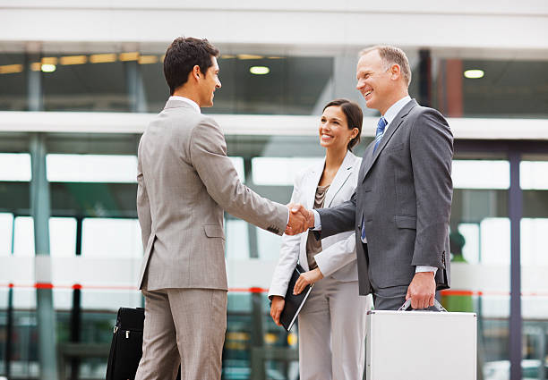 Businessmen shaking hands outdoors  briefcase photos stock pictures, royalty-free photos & images