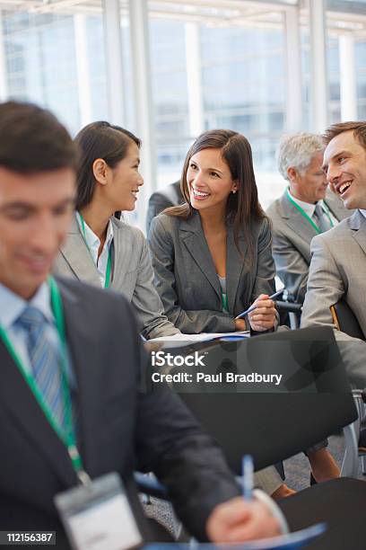 Business People Attending Seminar In Office Stock Photo - Download Image Now - Badge, Meeting, Lanyard