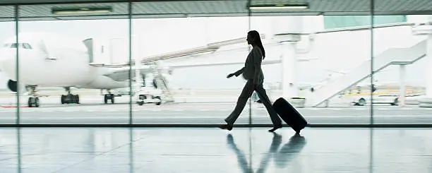 Photo of Businesswoman with suitcase in airport