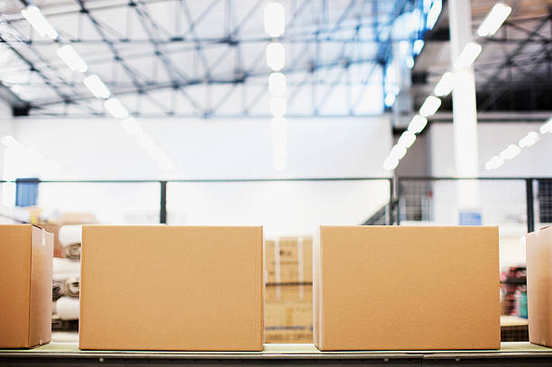 Boxes in row in shipping area  cardboard box stock pictures, royalty-free photos & images