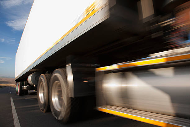 Semi-truck speeding on remote road  truck photos stock pictures, royalty-free photos & images
