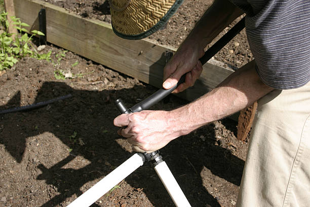 istock Man Joining Plastic Piping for Garden Irrigation 112253761