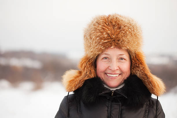 istock happy mature woman in winter 112256272