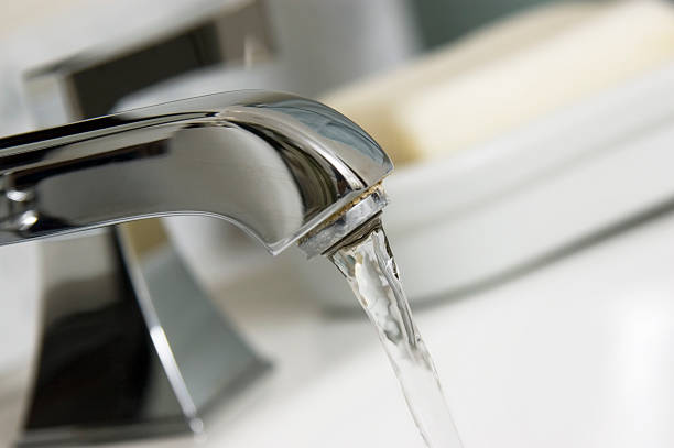 istock Close-up of a running silver bathroom faucet 112257888