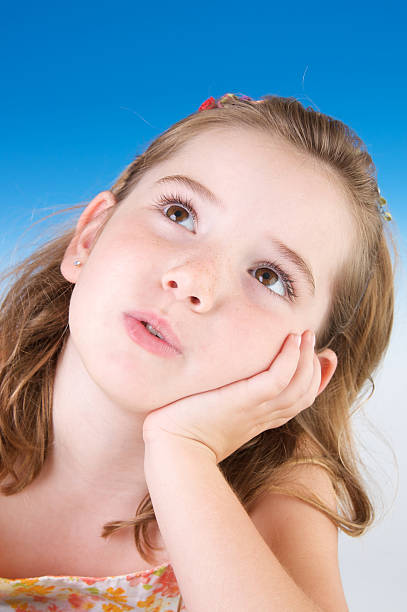istock Beautiful Girl on Blue Background Looking Up 112263368