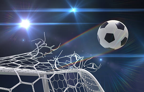 Football in the back of the goal, shot against a blue summer sky.