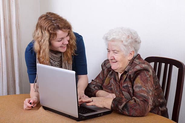 istock Young woman teaching older woman how to use technology 112267109