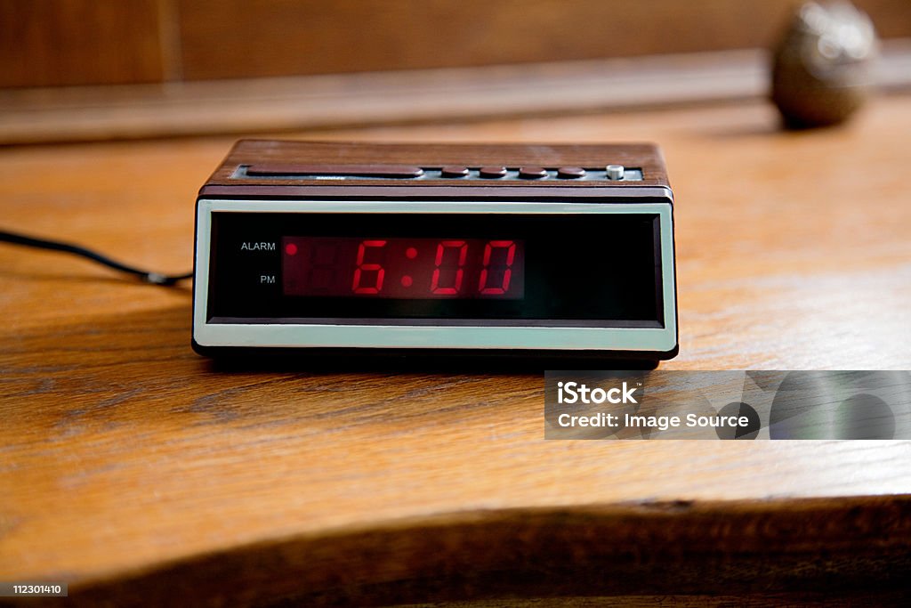Digital alarm clock showing 6.00am  Alarm Clock Stock Photo