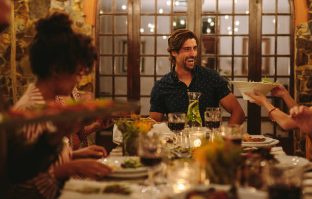 istock Group of friends enjoying dinner party 1124220288