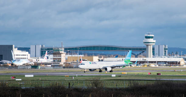 A Level Airlines Airbus A321-200 plane taxis after landing at London Gatwick Airport, with the air traffic control tower in the background Gatwick Airport, England, UK – December 09 2018: A Level Airlines Airbus A321-200 plane taxis after landing at London Gatwick Airport, with the air traffic control tower in the background. Copy space included. gatwick airport photos stock pictures, royalty-free photos & images