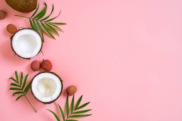 istock Pink tropical background with coconut and palm leaves 1124223604