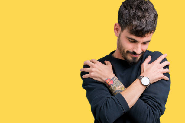 istock Young handsome man over isolated background Hugging oneself happy and positive, smiling confident. Self love and self care 1124223624