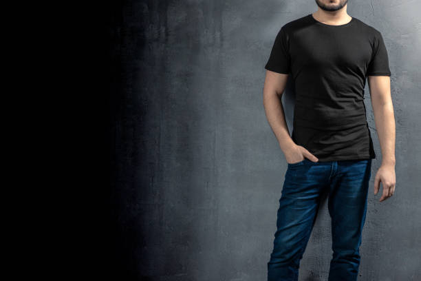 istock Young healthy man with black T-shirt on concrete background with copyspace for your text 1124223690
