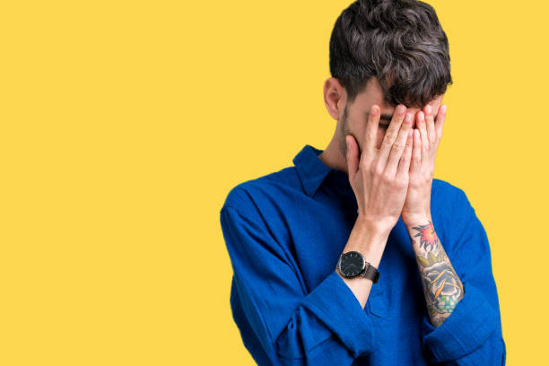 istock Young handsome man over isolated background with sad expression covering face with hands while crying. Depression concept. 1124223870