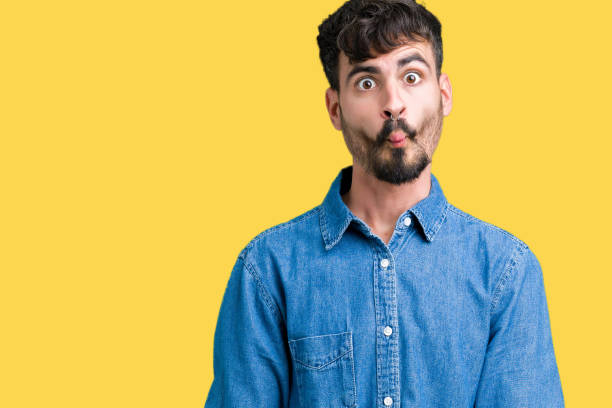 istock Young handsome man over isolated background making fish face with lips, crazy and comical gesture. Funny expression. 1124224065