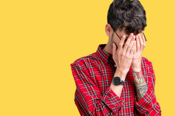 istock Young handsome man wearing glasses over isolated background with sad expression covering face with hands while crying. Depression concept. 1124224476