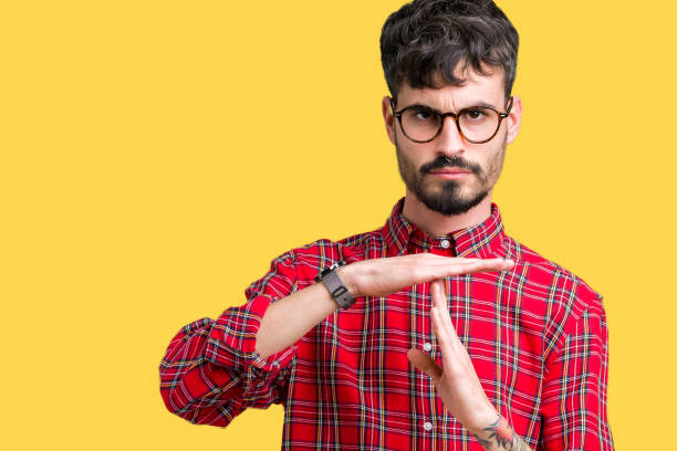 istock Young handsome man wearing glasses over isolated background Doing time out gesture with hands, frustrated and serious face 1124224500