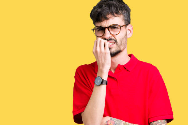 istock Young handsome man wearing glasses over isolated background looking stressed and nervous with hands on mouth biting nails. Anxiety problem. 1124224554