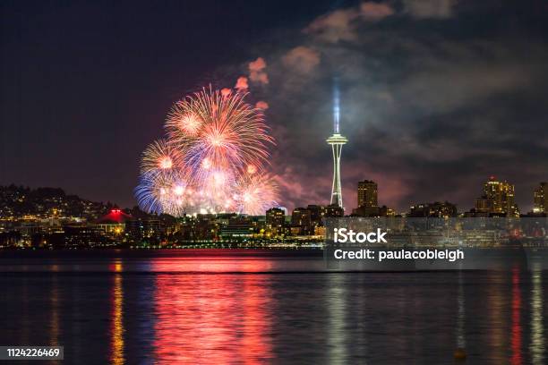 Lake Union 4th Of July Fireworks And The Seattle Skyline As Seen From Across Elliott Bay At Seacrest Park In West Seattle Wa Usa Stock Photo - Download Image Now