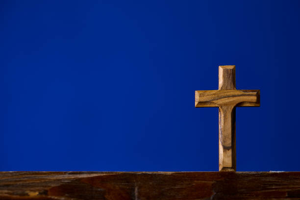 istock Brown wooden crucifix on blue background 1124226645