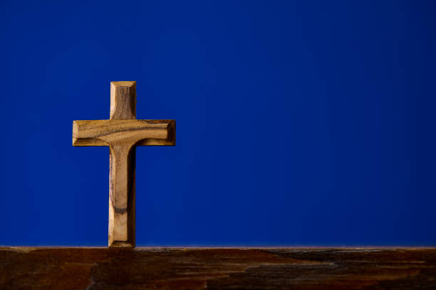 istock Brown wooden crucifix on blue background 1124226678