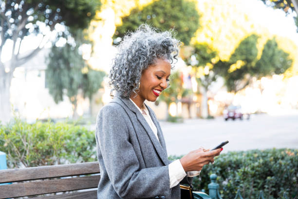 istock Black Woman Texting at Bus Stop 1124226704