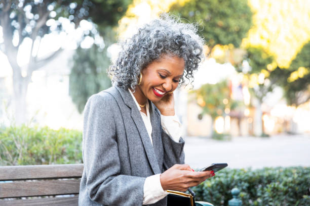 istock Black Woman Texting at Bus Stop 1124226800