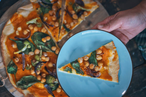 istock Preparing Vegan Pumpkin Pizza with Broccoli, Chickpeas and Spinach 1124228250
