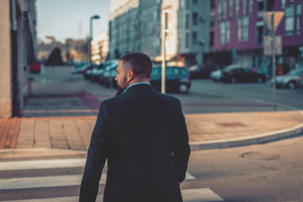 istock Businessman walking outdoors and talking on mobile phone 1124228423
