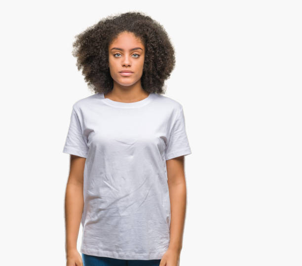 istock Young afro american woman over isolated background with serious expression on face. Simple and natural looking at the camera. 1124229730