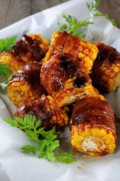 istock Grilled corn wrapped with bacon slices under BBQ sauce 1124233479