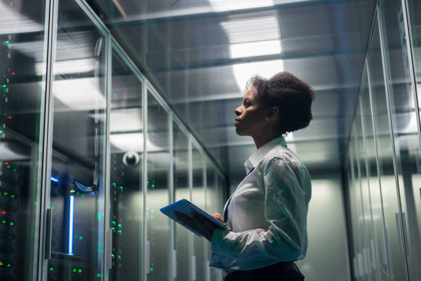 istock Female technician works on a tablet in a data center 1124233519