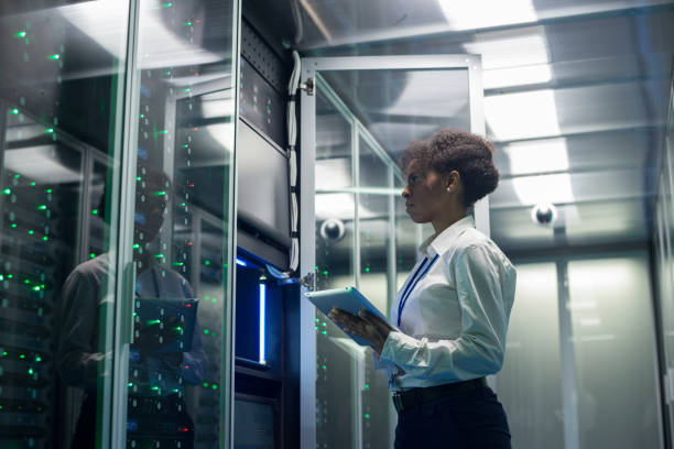 istock Female technician works on a tablet in a data center 1124233541
