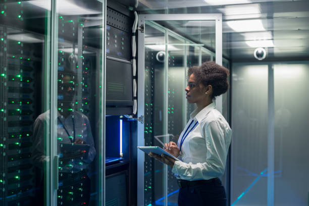 istock Female technician works on a tablet in a data center 1124233550